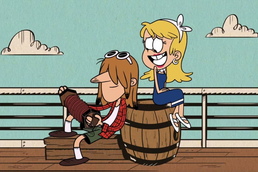 blonde woman sitting on a barrel with a casula dude playing an accordion